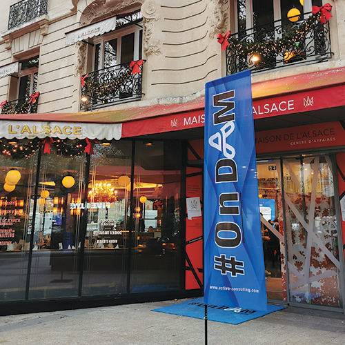 Photo taken in front of the Maison de l'Alsace building in Paris and we see a flame with the logo of the consulting firm Activo