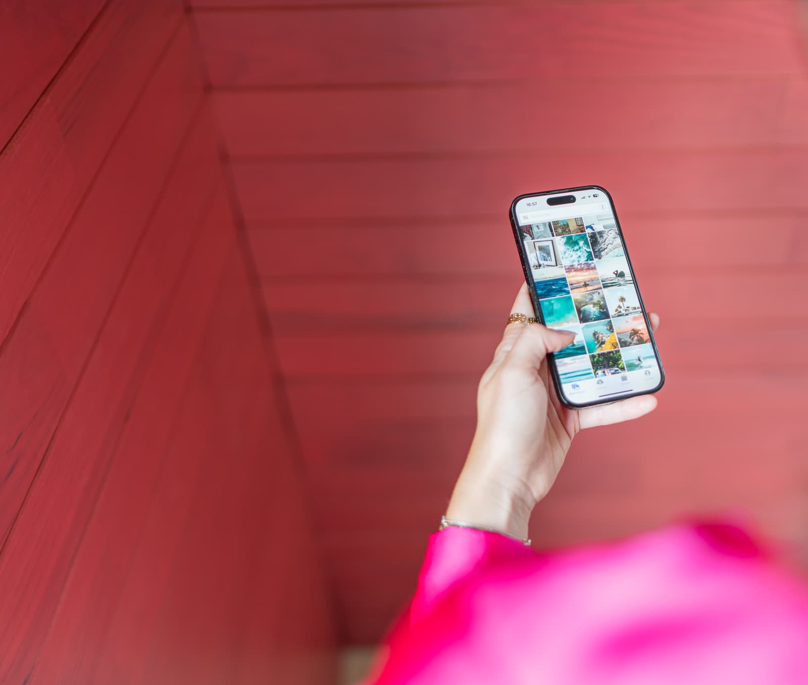 Woman holding a smartphone and looking at the Ephoto Dam IOS application.