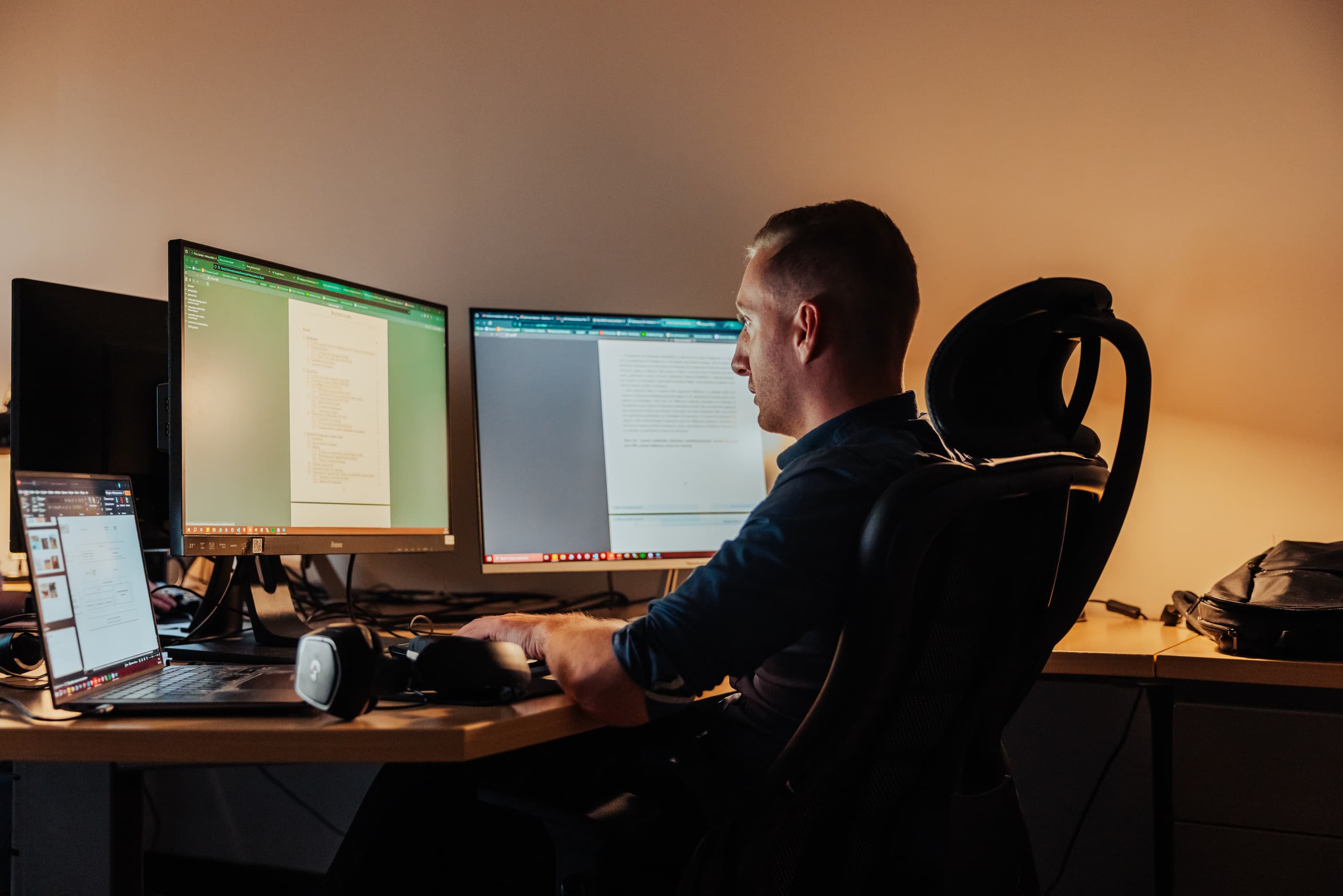 Two men in a meeting using computers to index media in Ephoto Dam.