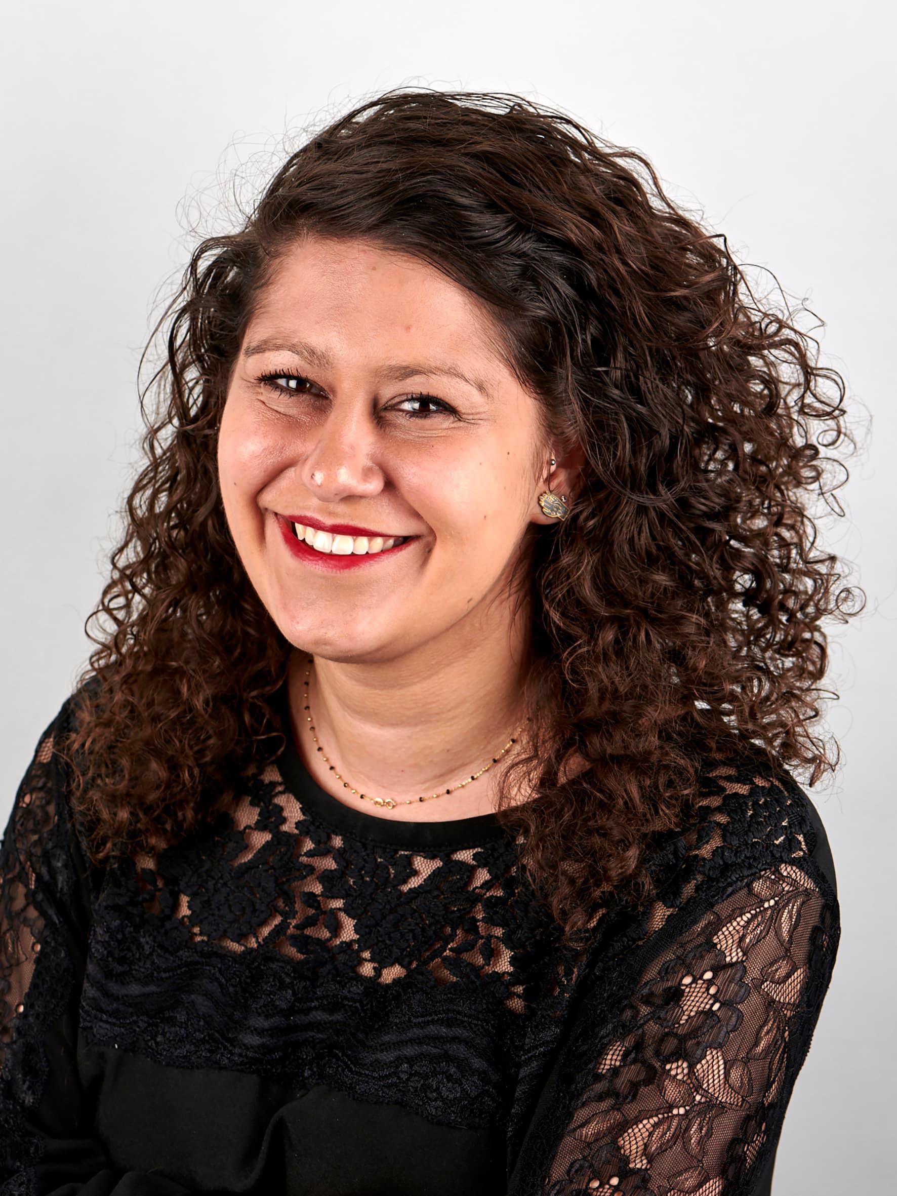 Portrait photo of a woman with curly hair.