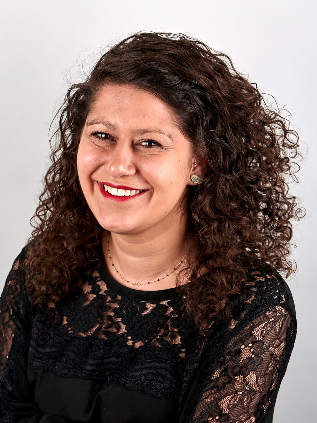 Portrait photo of a woman with curly hair.